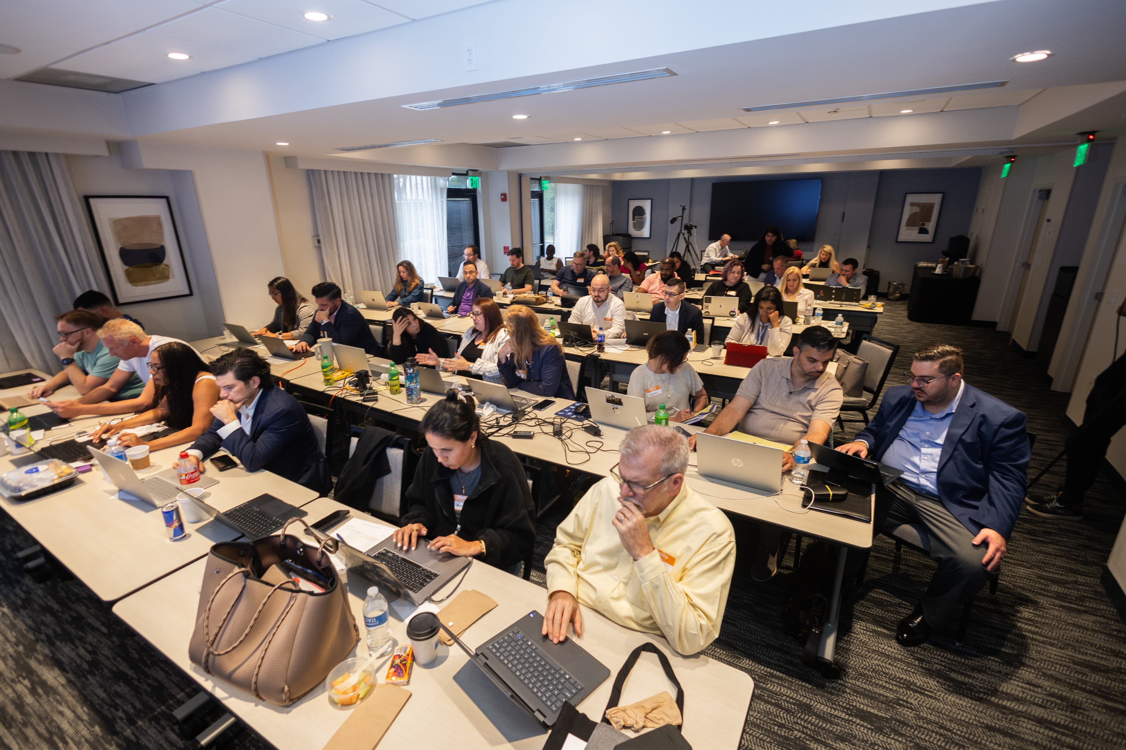 Attorneys working on laptops during a Next Level Lawyer training event.